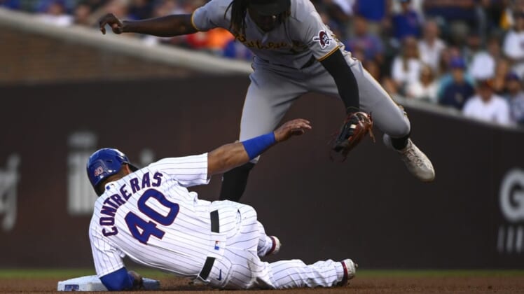 Jul 25, 2022; Chicago, Illinois, USA; Pittsburgh Pirates shortstop Oneil Cruz (top) tags out Chicago Cubs catcher Willson Contreras (40) during the first inning at Wrigley Field. Mandatory Credit: Matt Marton-USA TODAY Sports