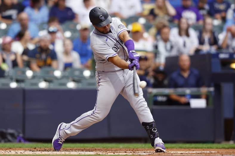 Jul 25, 2022; Milwaukee, Wisconsin, USA;  Colorado Rockies catcher Elias D az (35) hits a home run during the third inning against the Milwaukee Brewers at American Family Field. Mandatory Credit: Jeff Hanisch-USA TODAY Sports