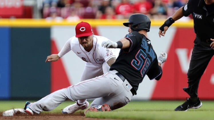 Jul 26, 2022; Cincinnati, Ohio, USA; Miami Marlins catcher Jacob Stallings (58) is tagged out at second against Cincinnati Reds second baseman Jonathan India (6) during the third inning at Great American Ball Park. Mandatory Credit: David Kohl-USA TODAY Sports