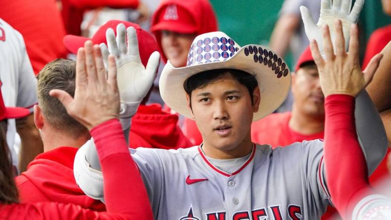 Jul 26, 2022; Kansas City, Missouri, USA; Los Angeles Angels designated hitter Shohei Ohtani (17) is congratulated in the dugout against the Kansas City Royals after hitting a solo home run in the third inning of the game at Kauffman Stadium. Mandatory Credit: Denny Medley-USA TODAY Sports