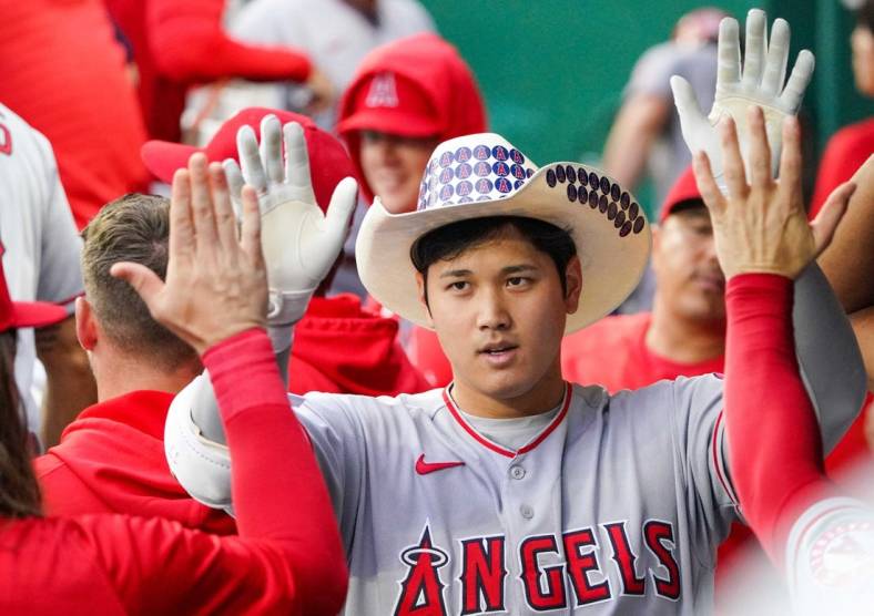 Jul 26, 2022; Kansas City, Missouri, USA; Los Angeles Angels designated hitter Shohei Ohtani (17) is congratulated in the dugout against the Kansas City Royals after hitting a solo home run in the third inning of the game at Kauffman Stadium. Mandatory Credit: Denny Medley-USA TODAY Sports