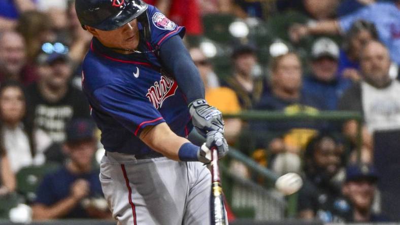 Jul 26, 2022; Milwaukee, Wisconsin, USA; Minnesota Twins third baseman Gio Urshela (15) hits a three run home run in the fifth inning against the Milwaukee Brewers at American Family Field. Mandatory Credit: Benny Sieu-USA TODAY Sports