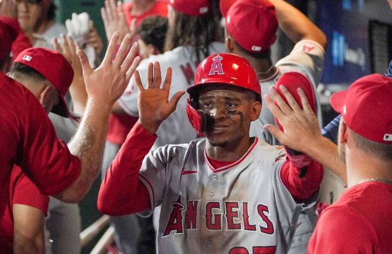 Jul 26, 2022; Kansas City, Missouri, USA; Los Angeles Angels center fielder Magneuris Sierra (37) is congratulated in the dugout against the Kansas City Royals after scoring in the seventh inning of the game at Kauffman Stadium. Mandatory Credit: Denny Medley-USA TODAY Sports
