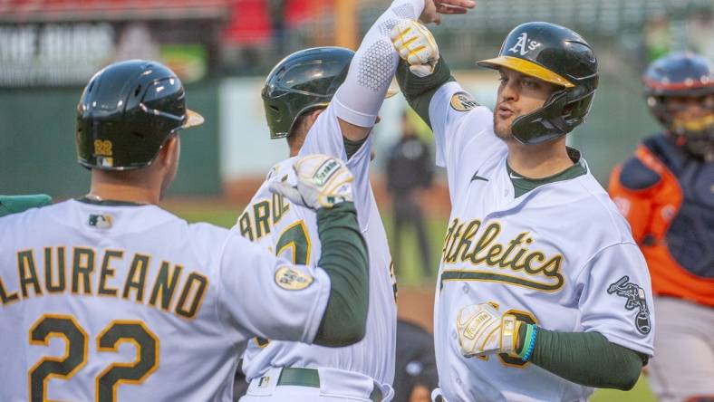 Jul 26, 2022; Oakland, California, USA; Oakland Athletics left fielder Chad Pinder (10) celebrates with third baseman Jonah Bride (77) and right fielder Ramon Laureano (22) after hitting a grand slam during the third inning against the Houston Astros at RingCentral Coliseum. Mandatory Credit: Ed Szczepanski-USA TODAY Sports