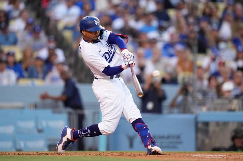 Jul 26, 2022; Los Angeles, California, USA; Los Angeles Dodgers right fielder Mookie Betts (50) follows through on a solo home run in the first inning against the Washington Nationals at Dodger Stadium. Mandatory Credit: Kirby Lee-USA TODAY Sports