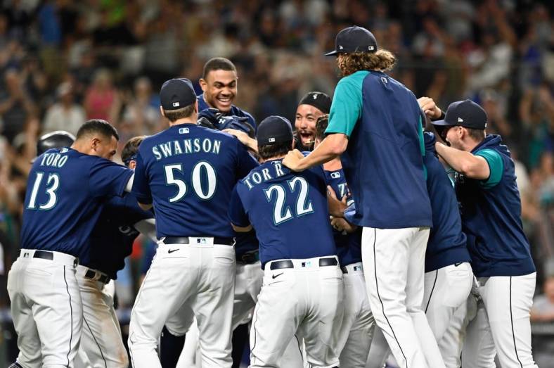 Jul 26, 2022; Seattle, Washington, USA; The Seattle Mariners celebrate after defeating the Texas Rangers at T-Mobile Park. Seattle defeated Texas 5-4. Mandatory Credit: Steven Bisig-USA TODAY Sports