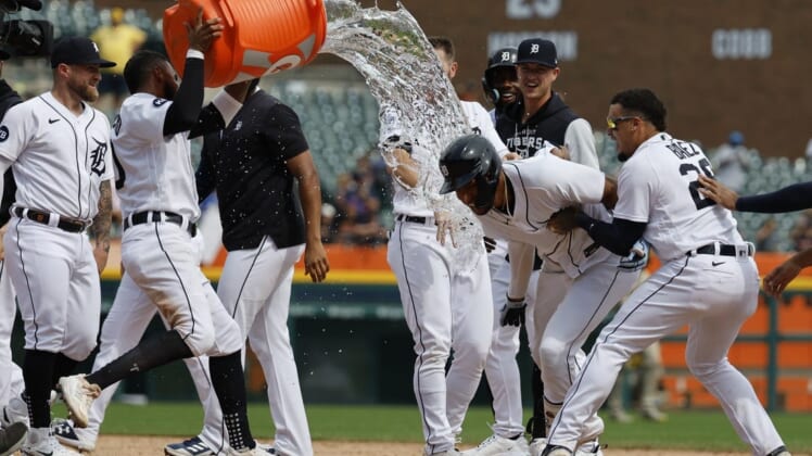 Jul 27, 2022; Detroit, Michigan, USA; Detroit Tigers right fielder Victor Reyes (22) receives congratulations from teammates after he hits a walk off two RBI double in the ninth inning against the San Diego Padres at Comerica Park. Mandatory Credit: Rick Osentoski-USA TODAY Sports
