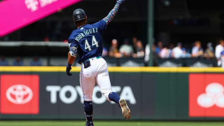 Jul 27, 2022; Seattle, Washington, USA; Seattle Mariners center fielder Julio Rodriguez (44) points to the sky as he rounds the bases after hitting a three-run home run against the Texas Rangers during the seventh inning at T-Mobile Park. Mandatory Credit: Lindsey Wasson-USA TODAY Sports