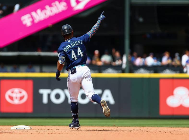 Jul 27, 2022; Seattle, Washington, USA; Seattle Mariners center fielder Julio Rodriguez (44) points to the sky as he rounds the bases after hitting a three-run home run against the Texas Rangers during the seventh inning at T-Mobile Park. Mandatory Credit: Lindsey Wasson-USA TODAY Sports