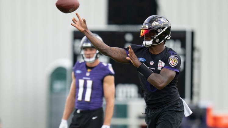 Jul 27, 2022; Owings Mills, MD, USA; Baltimore Ravens quarterback Lamar Jackson (8) throws the ball during day one of training camp at Under Armour Performance Center. Mandatory Credit: Jessica Rapfogel-USA TODAY Sports
