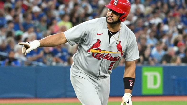 Jul 27, 2022; Toronto, Ontario, CAN;  St. Louis Cardinals first baseman Albert Pujols (5) reacts after hitting a three run home run against the Toronto Blue Jays in the fifth inning at Rogers Centre. Mandatory Credit: Dan Hamilton-USA TODAY Sports