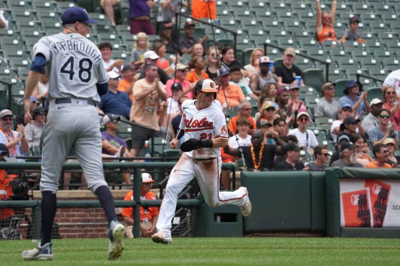 Jul 28, 2022; Baltimore, Maryland, USA; Baltimore Orioles outfielder Austin Hays (21) scores in the third inning against the Tampa Bay Rays at Oriole Park at Camden Yards. Mandatory Credit: Mitch Stringer-USA TODAY Sports