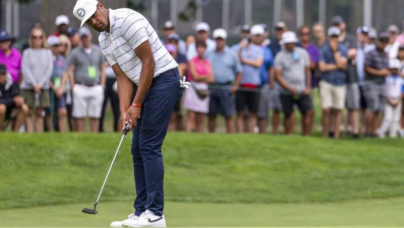 Jul 28, 2022; Detroit, Michigan, USA; Tony Finau putts on the ninth green during the first round of the Rocket Mortgage Classic golf tournament. Mandatory Credit: Raj Mehta-USA TODAY Sports