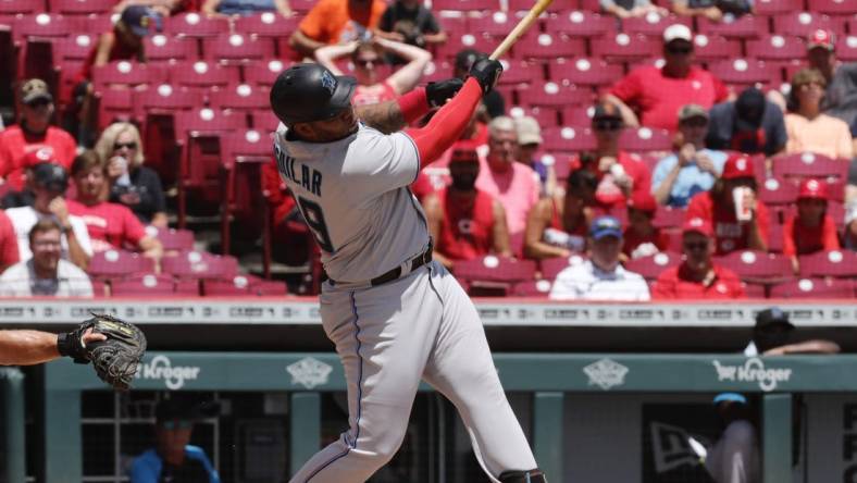 Jul 28, 2022; Cincinnati, Ohio, USA; Miami Marlins designated hitter Jesus Aguilar (99) hits a two-run home run against the Cincinnati Reds during the third inning at Great American Ball Park. Mandatory Credit: David Kohl-USA TODAY Sports