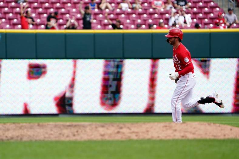 Cincinnati Reds right fielder Tyler Naquin (12) rounds the bases after hitting a solo home run during the sixth inning of a baseball game against the Miami Marlins, Thursday, July 28, 2022, at Great American Ball Park in Cincinnati.

Miami Marlins At Cincinnati Reds July 27 0025
