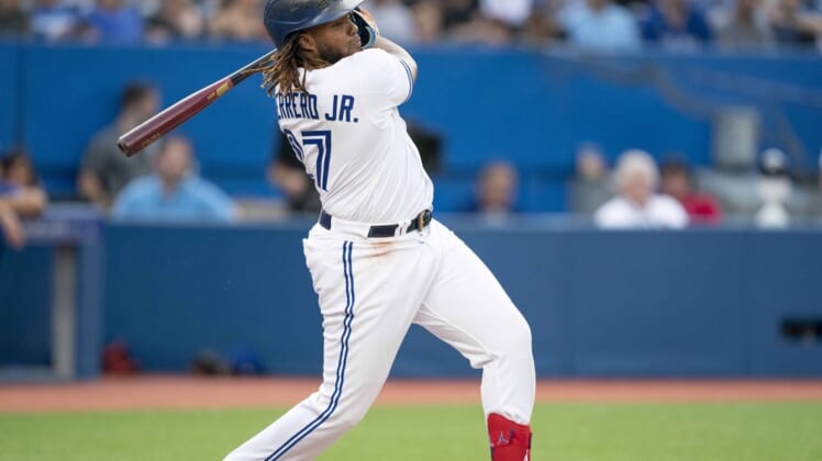 Jul 28, 2022; Toronto, Ontario, CAN; Toronto Blue Jays first baseman Vladimir Guerrero Jr. (27) hits a double against the Detroit Tigers during the first inning at Rogers Centre. Mandatory Credit: Nick Turchiaro-USA TODAY Sports