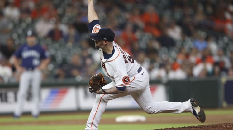 Jul 28, 2022; Houston, Texas, USA; Houston Astros relief pitcher Ryan Pressly (55) pitches against the Seattle Mariners in the ninth inning at Minute Maid Park. Mandatory Credit: Thomas Shea-USA TODAY Sports