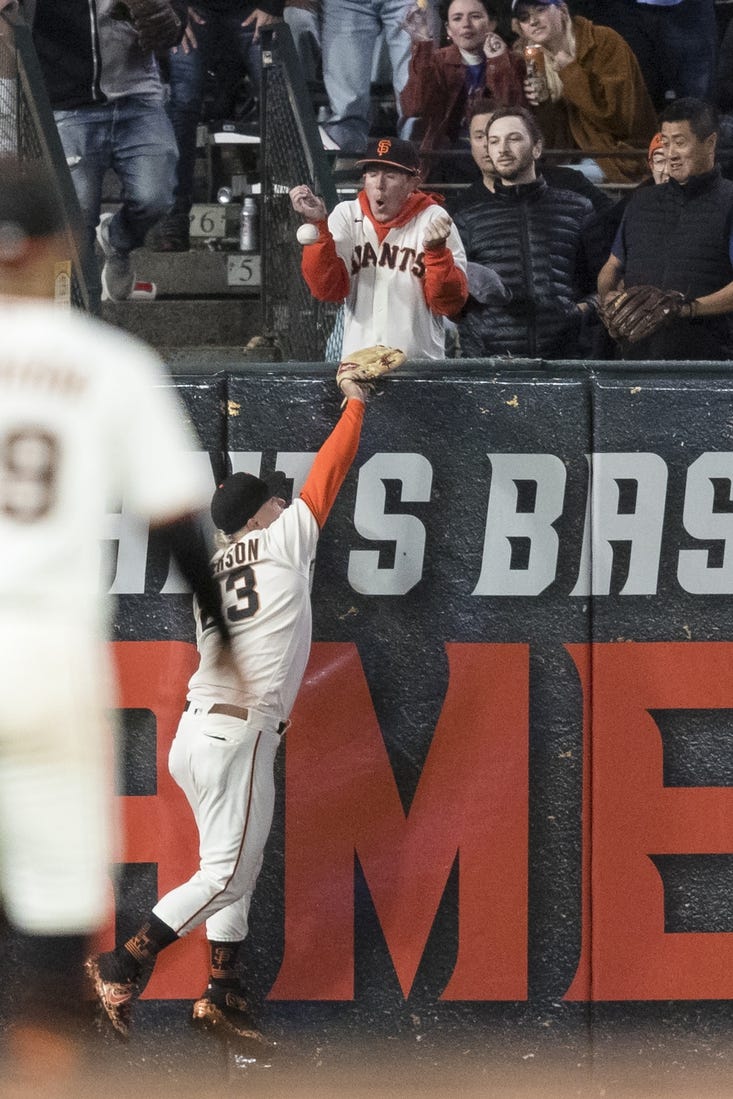 Jul 28, 2022; San Francisco, California, USA;  San Francisco Giants left fielder Joc Pederson (23) misses a deep fly ball to allow Chicago Cubs third baseman Patrick Wisdom (16) a two-run home run during the seventh inning at Oracle Park. Mandatory Credit: John Hefti-USA TODAY Sports