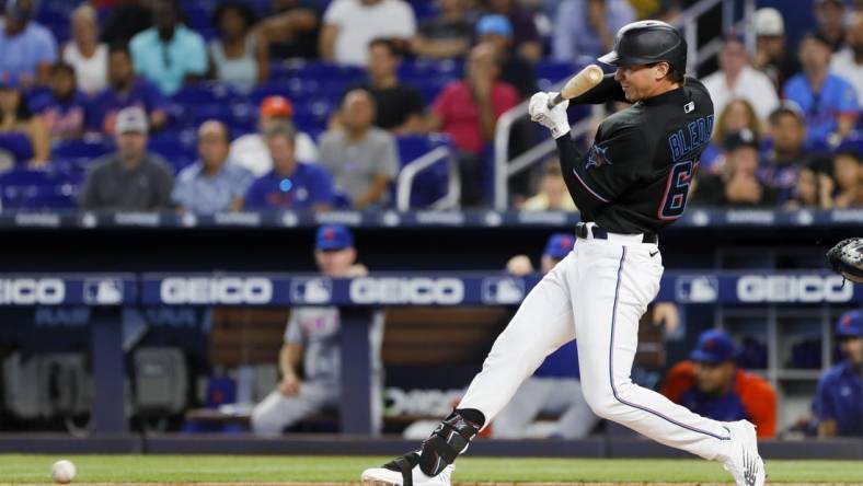 Jul 29, 2022; Miami, Florida, USA; Miami Marlins center fielder JJ Bleday (67) hits an infield hit during the first inning against the New York Mets at loanDepot Park. Mandatory Credit: Sam Navarro-USA TODAY Sports