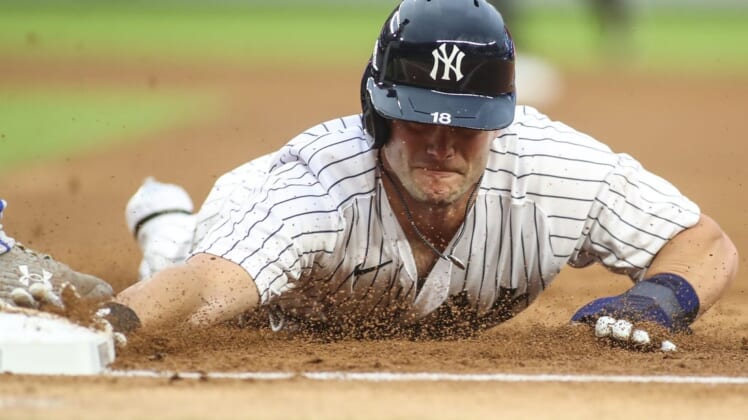 Jul 29, 2022; Bronx, New York, USA;  New York Yankees left fielder Andrew Benintendi (18) dives back to first base on a pick off attempt in the second inning against the Kansas City Royals at Yankee Stadium. Mandatory Credit: Wendell Cruz-USA TODAY Sports