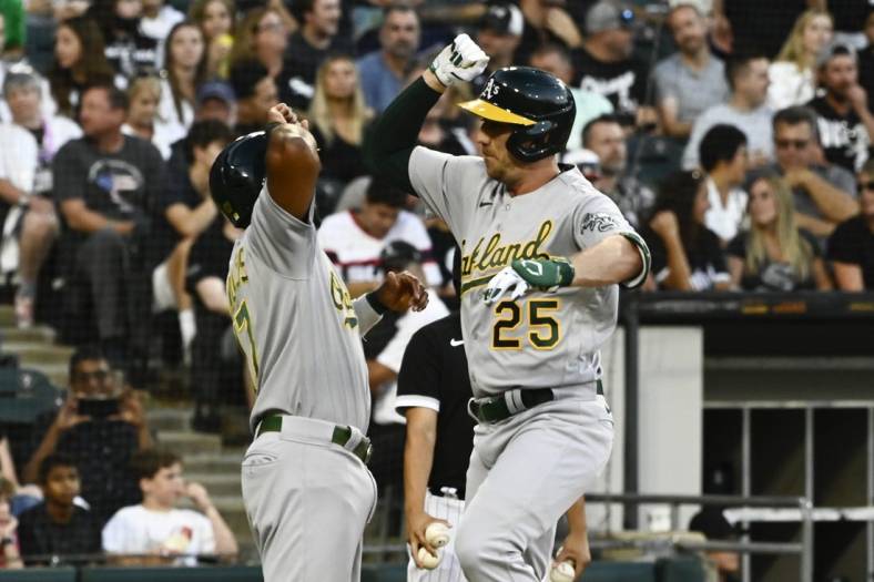 Jul 29, 2022; Chicago, Illinois, USA;  Oakland Athletics right fielder Stephen Piscotty (25) right, high fives Oakland Athletics shortstop Elvis Andrus (17) after they score on Piscotty's  three-run home run against the Chicago White Sox during the second inning at Guaranteed Rate Field. Mandatory Credit: Matt Marton-USA TODAY Sports