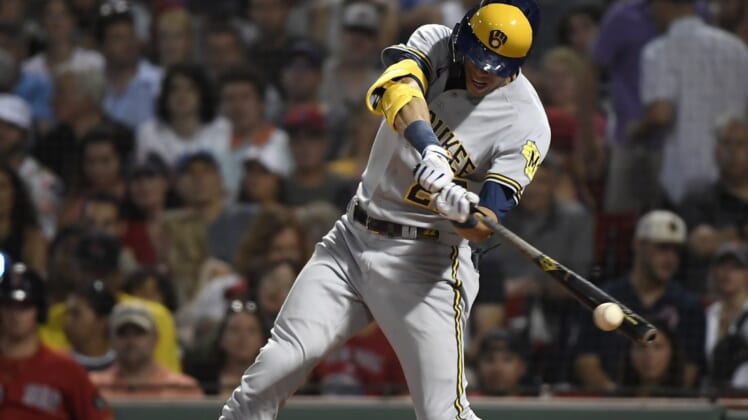 Jul 29, 2022; Boston, Massachusetts, USA;  Milwaukee Brewers left fielder Christian Yelich (22) hits a double during the sixth inning against the Boston Red Sox at Fenway Park. Mandatory Credit: Bob DeChiara-USA TODAY Sports