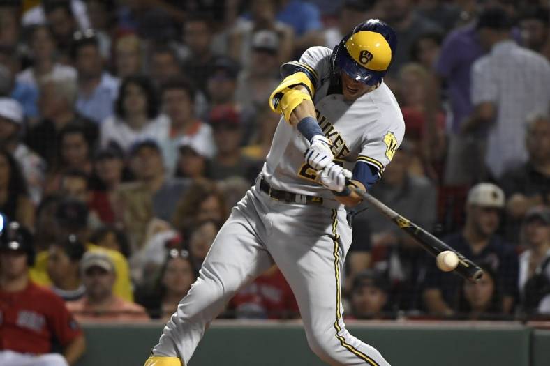 Jul 29, 2022; Boston, Massachusetts, USA;  Milwaukee Brewers left fielder Christian Yelich (22) hits a double during the sixth inning against the Boston Red Sox at Fenway Park. Mandatory Credit: Bob DeChiara-USA TODAY Sports