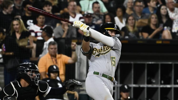 Jul 29, 2022; Chicago, Illinois, USA;  Oakland Athletics first baseman Seth Brown (15) hits a home run against the Chicago White Sox during the sixth inning at Guaranteed Rate Field. Mandatory Credit: Matt Marton-USA TODAY Sports