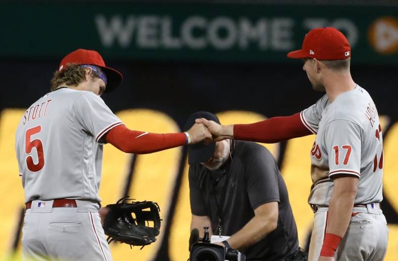 Jul 29, 2022; Pittsburgh, Pennsylvania, USA;  Philadelphia Phillies second baseman Bryson Stott (5) and first baseman Rhys Hoskins (right) celebrate after defeating the Pittsburgh Pirates at PNC Park. The Phillies won 4-2 in ten innings. Mandatory Credit: Charles LeClaire-USA TODAY Sports