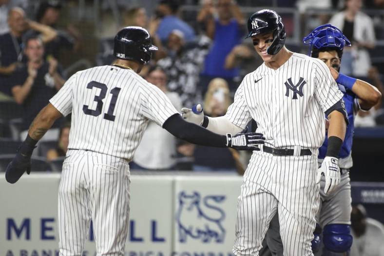 Jul 29, 2022; Bronx, New York, USA;  New York Yankees center fielder Aaron Hicks (31) greets right fielder Aaron Judge (99) after he hit a grand slam home run in the eighth inning against the Kansas City Royals at Yankee Stadium. Mandatory Credit: Wendell Cruz-USA TODAY Sports