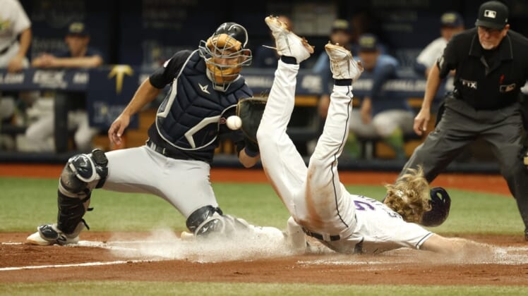 Jul 30, 2022; St. Petersburg, Florida, USA; Tampa Bay Rays shortstop Taylor Walls (6) slides safe into home plate as Cleveland Guardians catcher Luke Maile (12) attempted to tag him out during the second inning at Tropicana Field. Mandatory Credit: Kim Klement-USA TODAY Sports