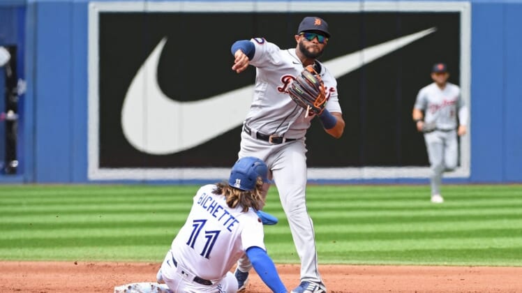 Jul 31, 2022; Toronto, Ontario, CAN; Detroit Tigers second base Willi Castro (9) turns a double play over Toronto Blue Jays short stop Bo Bichette (11) in the fourth inning at Rogers Centre. Mandatory Credit: Gerry Angus-USA TODAY Sports