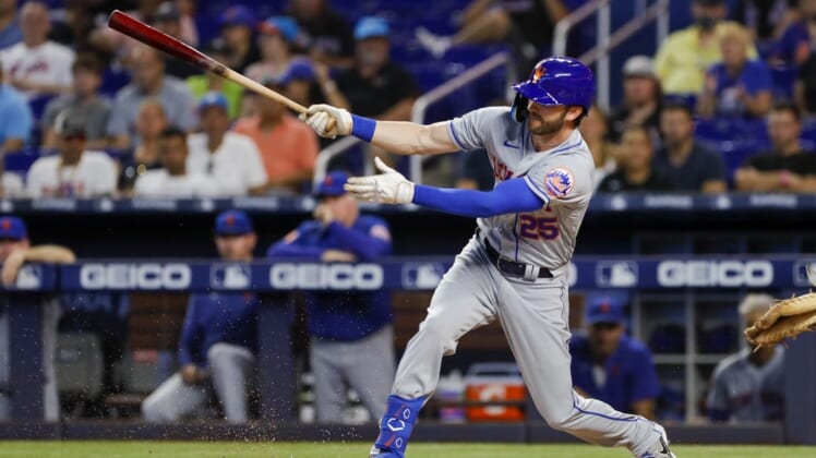 Jul 31, 2022; Miami, Florida, USA; New York Mets right fielder Tyler Naquin (25) hits a single during the first inning against the Miami Marlins at loanDepot Park. Mandatory Credit: Sam Navarro-USA TODAY Sports
