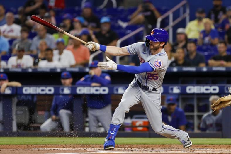 Jul 31, 2022; Miami, Florida, USA; New York Mets right fielder Tyler Naquin (25) hits a single during the first inning against the Miami Marlins at loanDepot Park. Mandatory Credit: Sam Navarro-USA TODAY Sports