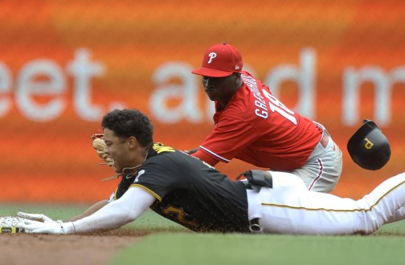 Jul 31, 2022; Pittsburgh, Pennsylvania, USA; Pittsburgh Pirates designated hitter Cal Mitchell (31) slides into second base for an RBI double as Philadelphia Phillies shortstop Didi Gregorius (18) looks to make a tag during the third inning at PNC Park. Mandatory Credit: Charles LeClaire-USA TODAY Sports