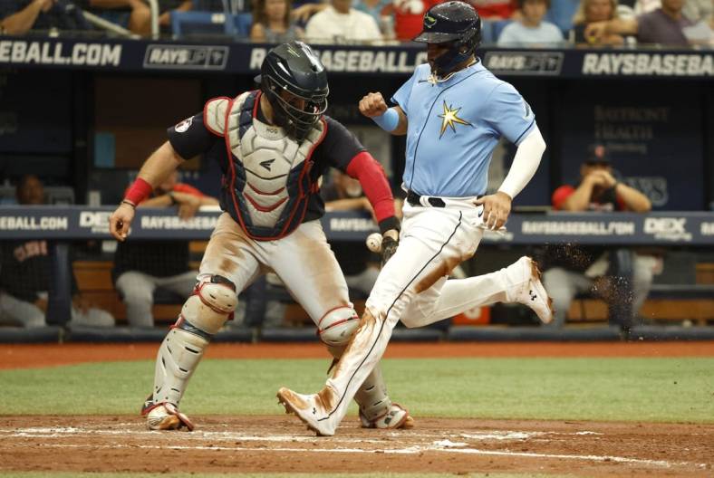 Jul 31, 2022; St. Petersburg, Florida, USA; Tampa Bay Rays second baseman Isaac Paredes (17) scores a run as Cleveland Guardians catcher Austin Hedges (17) attempts to tag him out during the second inning at Tropicana Field. Mandatory Credit: Kim Klement-USA TODAY Sports