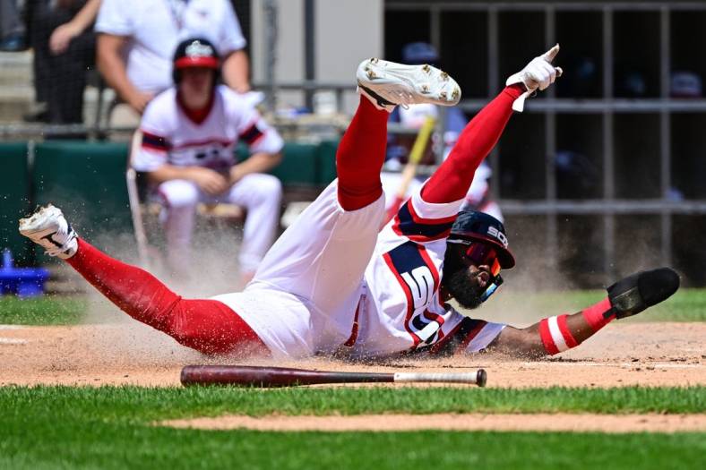 Jul 31, 2022; Chicago, Illinois, USA; Chicago White Sox second baseman Josh Harrison (5) celebrates while sliding at home to score in the second inning against the Oakland Athletics at Guaranteed Rate Field. Mandatory Credit: Quinn Harris-USA TODAY Sports