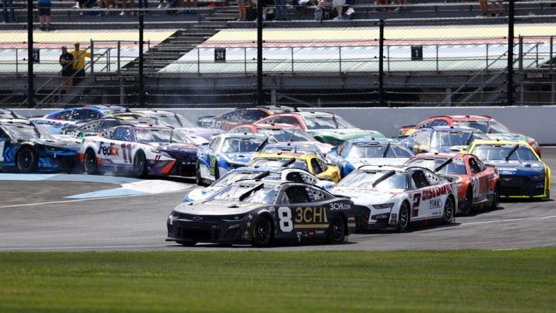 Jul 31, 2022; Speedway, Indiana, USA; NASCAR Cup Series driver Tyler Reddick (8) leads the field during the Verizon 200 at Indianapolis Motor Speedway Road Course. Mandatory Credit: Mike Dinovo-USA TODAY Sports