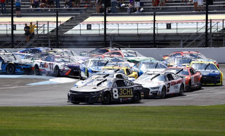 Jul 31, 2022; Speedway, Indiana, USA; NASCAR Cup Series driver Tyler Reddick (8) leads the field during the Verizon 200 at Indianapolis Motor Speedway Road Course. Mandatory Credit: Mike Dinovo-USA TODAY Sports
