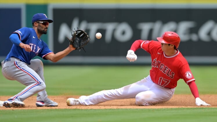 Jul 31, 2022; Anaheim, California, USA; Los Angeles Angels starting pitcher Shohei Ohtani (17) is caught stealing as he is tagged out by Texas Rangers second baseman Marcus Semien (2) in the third inning at Angel Stadium. Mandatory Credit: Jayne Kamin-Oncea-USA TODAY Sports