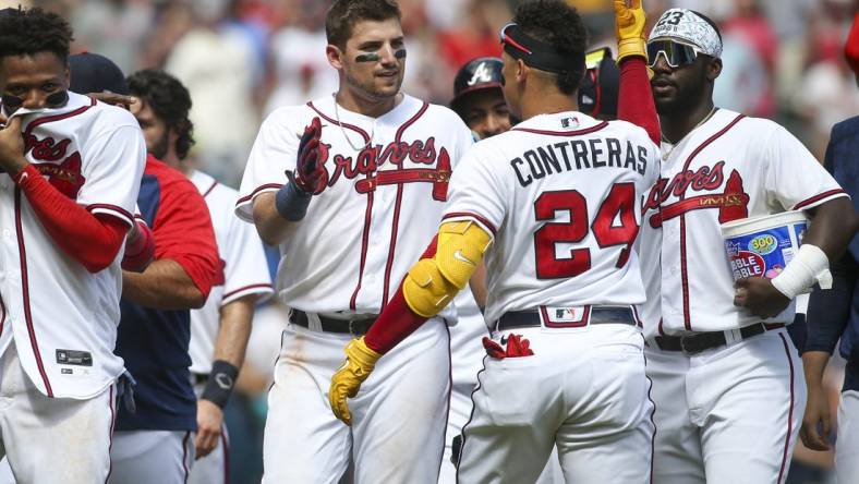 Jul 31, 2022; Atlanta, Georgia, USA; Atlanta Braves third baseman Austin Riley (27) celebrates with catcher William Contreras (24) after a game-winning RBI double against the Arizona Diamondbacks at Truist Park. Mandatory Credit: Brett Davis-USA TODAY Sports