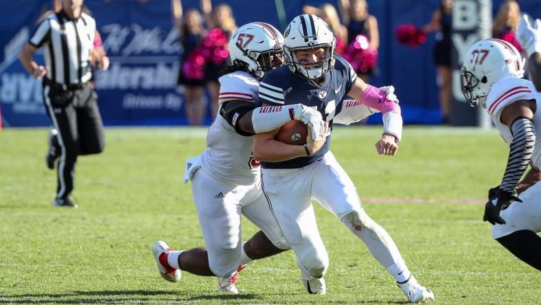 Oct 27, 2018; Provo, UT, USA; Brigham Young Cougars quarterback Zach Wilson (11) is tackled from behind by Northern Illinois Huskies linebacker Kyle Pugh (57) during the second half at LaVell Edwards Stadium. Northern Illinois Huskies won 7-6. Mandatory Credit: Chris Nicoll-USA TODAY Sports