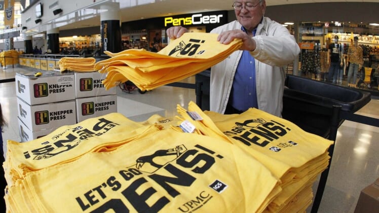Apr 14, 2019; Pittsburgh, PA, USA;  Workers prepare rally towels to be handed out to fans before the Pittsburgh Penguins host the New York Islanders in game three of the first round of the 2019 Stanley Cup Playoffs at PPG PAINTS Arena. Mandatory Credit: Charles LeClaire-USA TODAY Sports