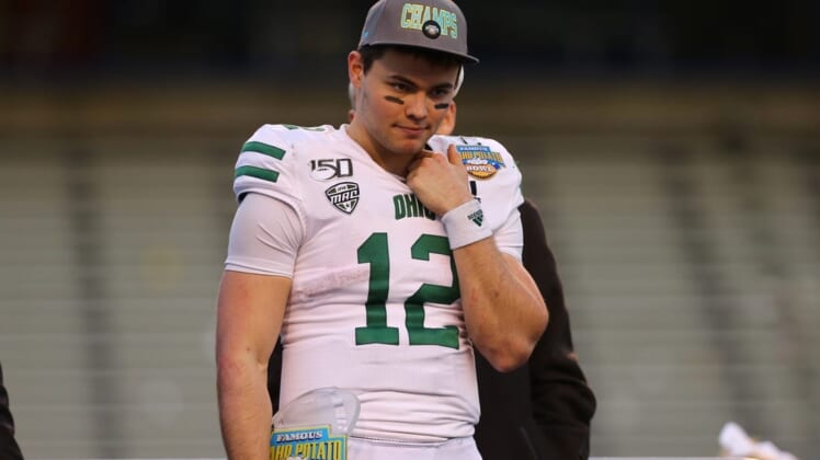 Jan 3, 2020; Boise, Idaho, USA; Ohio Bobcats quarterback Nathan Rourke (12) receives the Famous Idaho Potato Bowl most valuable player trophy after defeating the Nevada Wolf Pack at Albertsons Stadium. Ohio won 30-21. Mandatory Credit: Brian Losness-USA TODAY Sports