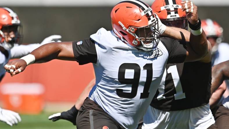 Aug 20, 2020; Berea, Ohio, USA;  Cleveland Browns defensive tackle Eli Ankou (91) rushes past offensive tackle Jedrick Wills Jr. (71) during training camp at the Cleveland Browns training facility. Mandatory Credit: Ken Blaze-USA TODAY Sports