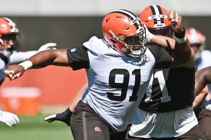 Aug 20, 2020; Berea, Ohio, USA;  Cleveland Browns defensive tackle Eli Ankou (91) rushes past offensive tackle Jedrick Wills Jr. (71) during training camp at the Cleveland Browns training facility. Mandatory Credit: Ken Blaze-USA TODAY Sports