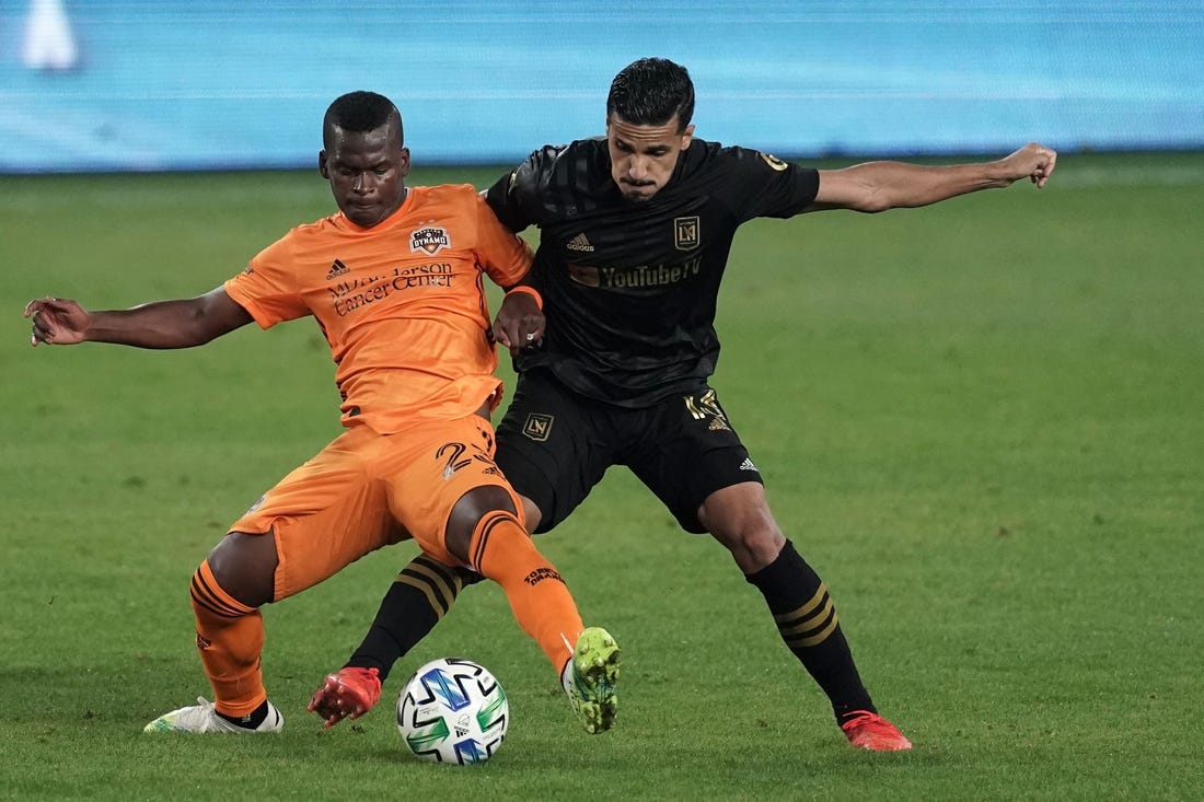 Oct 28, 2020; Los Angeles, CA, USA; Houston Dynamo midfielder Matias Vera (22) and LAFC defender Mohamed El-Munir (13) battle for the ball in the second half  at Banc of California Stadium.  Mandatory Credit: Kirby Lee-USA TODAY Sports