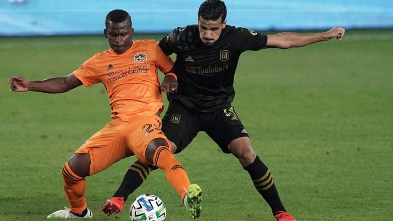 Oct 28, 2020; Los Angeles, CA, USA; Houston Dynamo midfielder Matias Vera (22) and LAFC defender Mohamed El-Munir (13) battle for the ball in the second half  at Banc of California Stadium.  Mandatory Credit: Kirby Lee-USA TODAY Sports