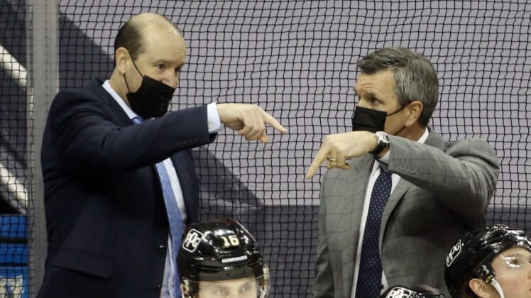 Feb 14, 2021; Pittsburgh, Pennsylvania, USA;  Pittsburgh Penguins assistant coach Todd Reirden (left) and head coach Mike Sullivan (right) talk on the bench against the Washington Capitals during the third period at PPG Paints Arena. The Penguins won 6-3. Mandatory Credit: Charles LeClaire-USA TODAY Sports