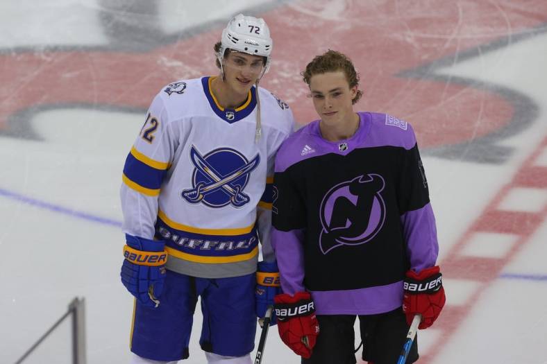 Apr 6, 2021; Newark, New Jersey, USA; Buffalo Sabres right wing Tage Thompson (72) and New Jersey Devils right wing Tyce Thompson (12) pose together during the pregame warmups at Prudential Center. It is the first career NHL game for Tyce Thompson. Mandatory Credit: Ed Mulholland-USA TODAY Sports